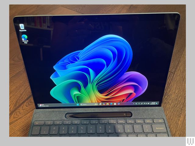 Closeup of a tablet screen and a slot holding a stylus just above the keyboard